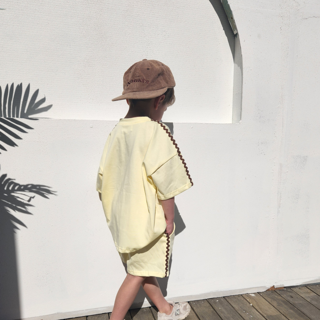side view of child wearing buttercup t-shirt and shorts set